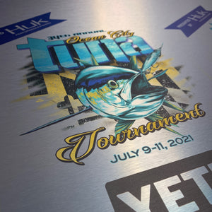 a closeup of an uncut award for the 2021 OC Tuna Tournament printed on brushed aluminum