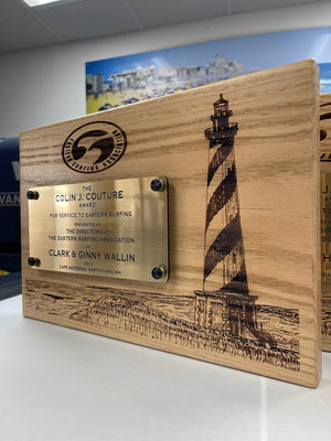 a photo of the ESA Doc Couture Awards on a laser engraved wood plank with a raised brushed metal nameplate