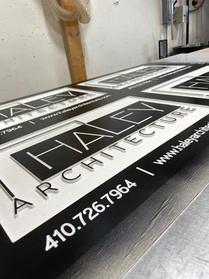 a photo of four black and white engraved rectangular signs