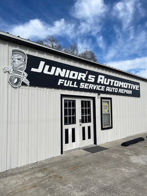 a photo of the Junior's Automotive sign mounted above the entrance