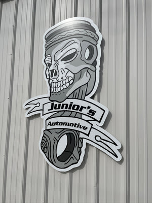 a photo of the Junior's Automotive logo sign mounted to the exterior wall