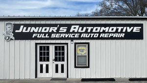 a photo of the Junior's Automotive sign mounted above the entrance