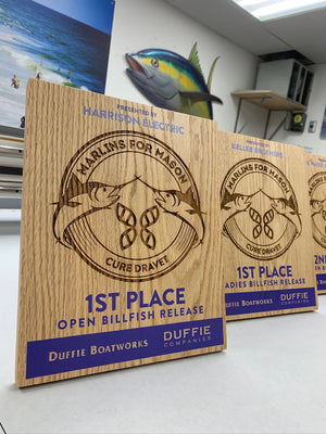 a photos of the Marlins for Mason 2023 awards on laser engraved wood with blue printed lettering