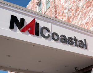 a photo of the NAI Coastal sign mounted above the entrance