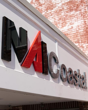 an angled closeup photo of the NAI Coastal sign