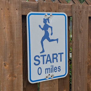 Start (0 miles) - Trail Marker Sign (Female)