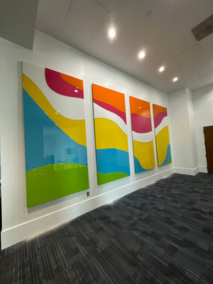 an angled photo of an abstract art piece made of multicolored rectangles mounted to a wall