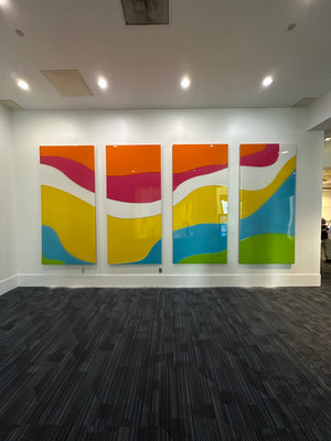 a photo of an abstract art piece made of multicolored rectangles mounted to a wall
