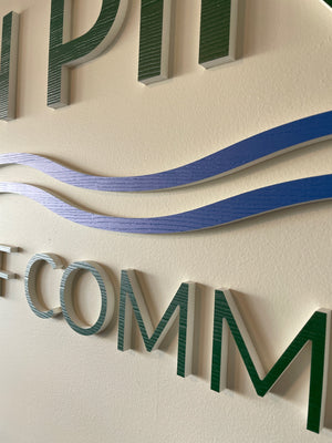 a closeup of the Ocean Pines Chamber of Commerce lettering mounted to a wall