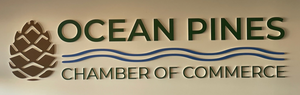 a photo of the Ocean Pines Chamber of Commerce lettering and logo mounted to a wall