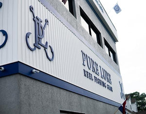 a photo of the Pure Lure lettering and logo mounted to the exterior wall