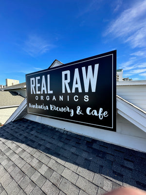 a photo of the Real Raw Organics sign mounted to the roof