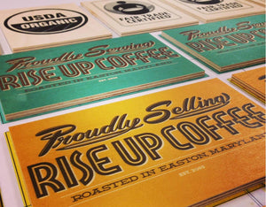 a photo of various Rise Up point of sale signs