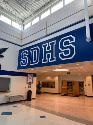 a photo of the SDHS letters mounted above a main hallway