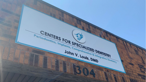 a photo of the final Centers for Specialized Dentistry sign mounted above the entrance