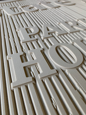 a closeup of the unpainted State Street Park sign showing the texture and raised lettering