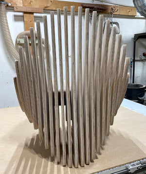 a photo of the back of a strange looking abstract wooden chair