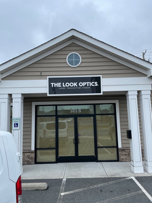 a photo of the sign for The Look Optics mounted above the entrance