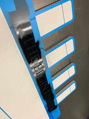 an angled photo of the unfinished Titanic house sign being painted