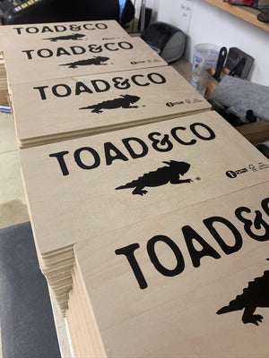 a photo of stacks of Toad & Co signs