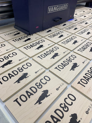 a photo of many Toad & Co signs being printed