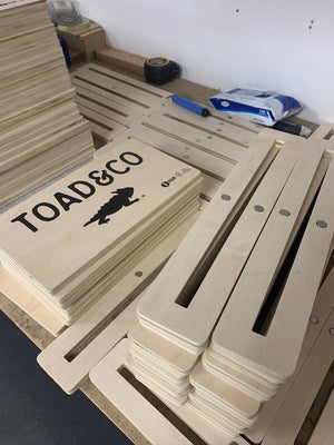 a photo of stacks of Toad & Co signs and magnetic bases