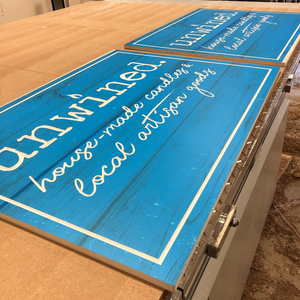 a photo of the unpainted Unwined signs