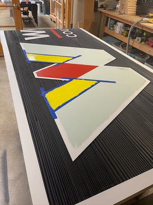 a photo of half of the WCPS Board of Education sign being painted