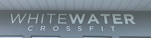 a photo of the lettering for Whitewater Crossfit mounted above the entrance