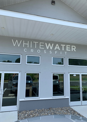 a photo of the lettering for Whitewater Crossfit mounted above the entrance