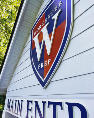 an angled closeup of the Worcester Prep logo and lettering mounted above the entrance