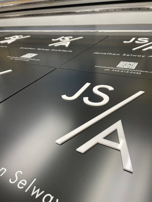 a closeup photo of the Jonathon Selway signs showing the raised white letters