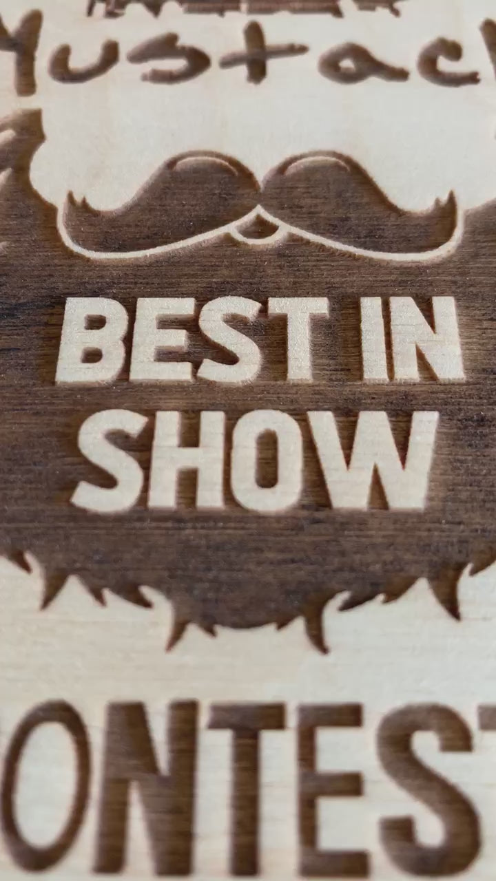 a video closeup of an award for the Bearded Men Society, a circular wooden plank with laser engraved text and the logo for the Mullet & Mustache contest 